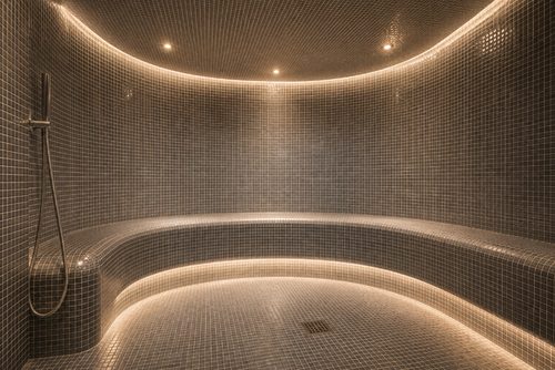 Curved mosaic steam room with ambient lighting